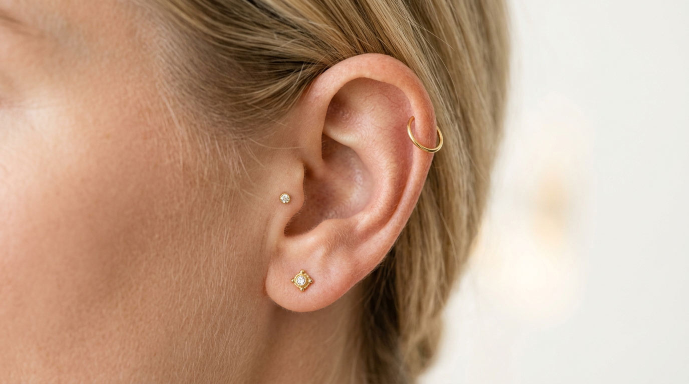 Detailed view of multiple ear piercings — helix, tragus, lobe healing times