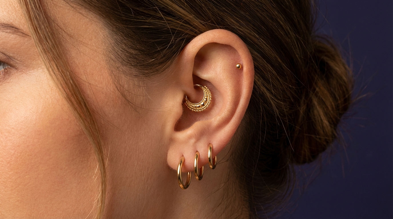 Woman's inner ear showing the daith pressure point at the crux of helix — vagus nerve auricular acupuncture point claimed to help migraine relief